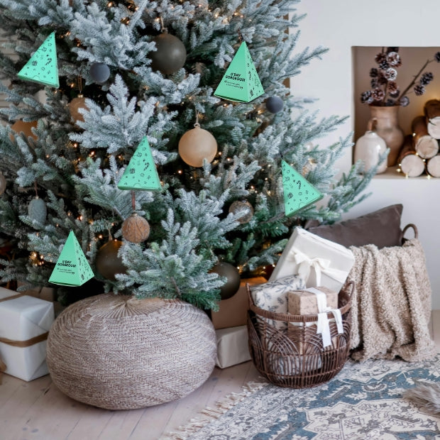 Decorated Christmas tree with christmas gifts in a cozy living room setting.