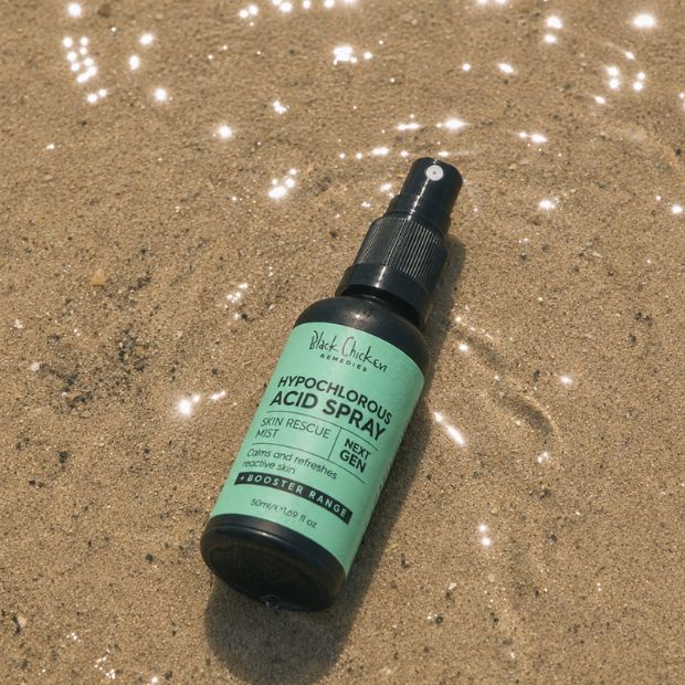 Black Chicken Hypochlorous Acid Spray – Skin Rescue Mist bottle on sand
