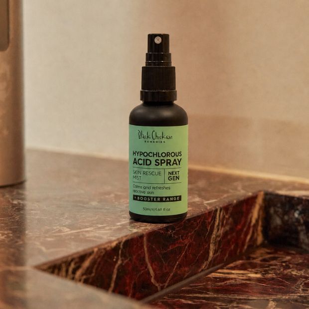 Black Chicken Hypochlorous Acid Spray – Skin Rescue Mist bottle on a marble bathroom counter